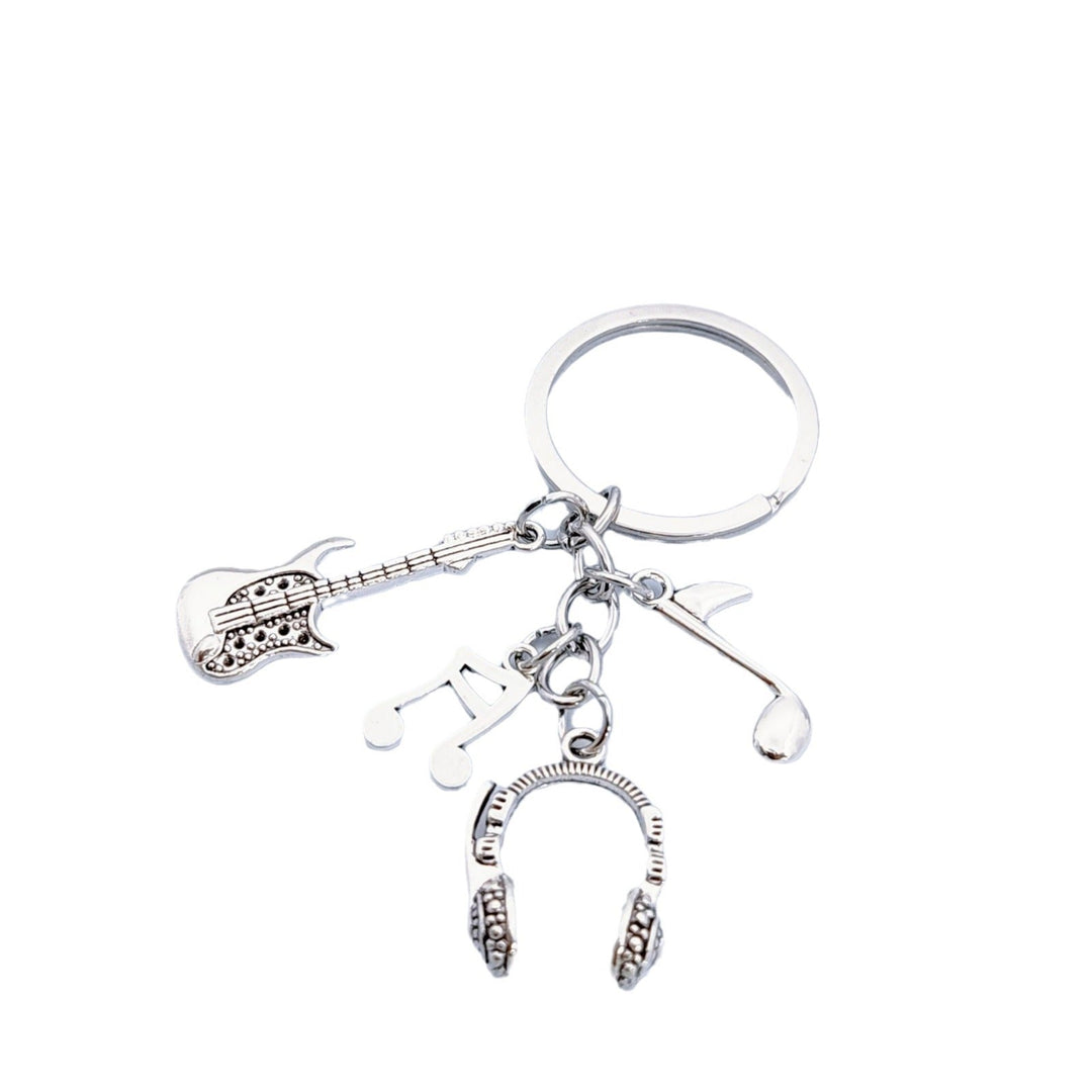 Assorted musical instrument charms on a metal keychain. Guitar, headphones, & music notes for music enthusiasts.