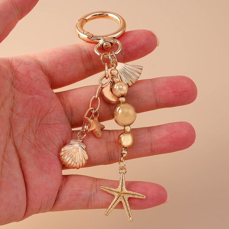 Maritime keyholder with a collection of ocean charms, a unique accessory for bags or everyday use.
