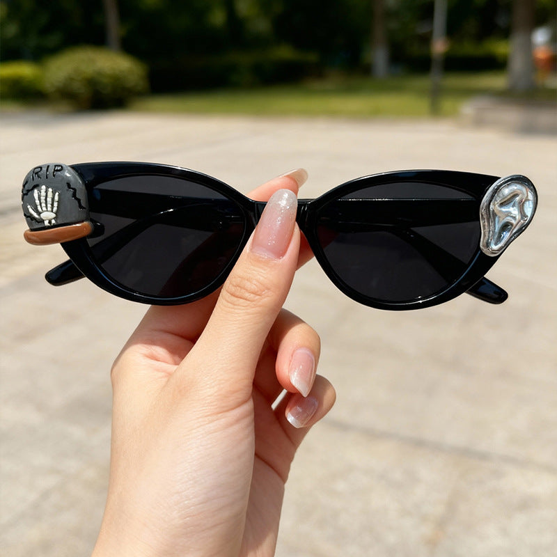 Fashion-forward unisex cat-eye novelty sunglasses, ideal for festivals, parties & making a statement. Offers UV protection.