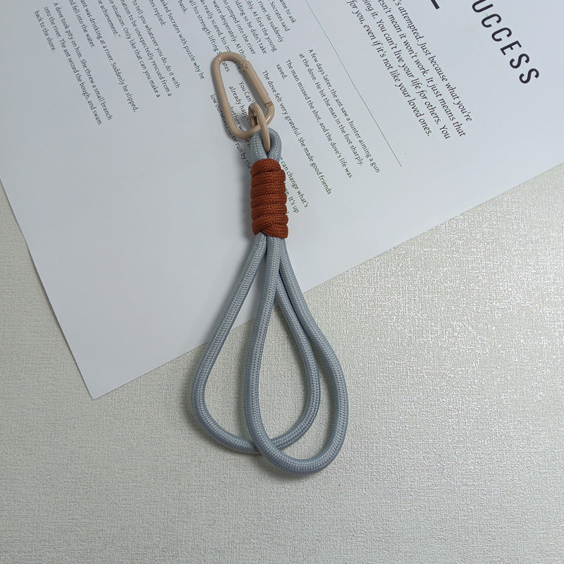 Compact paracord keychain for backpack or belt loop, enhancing outdoor utility & survival.