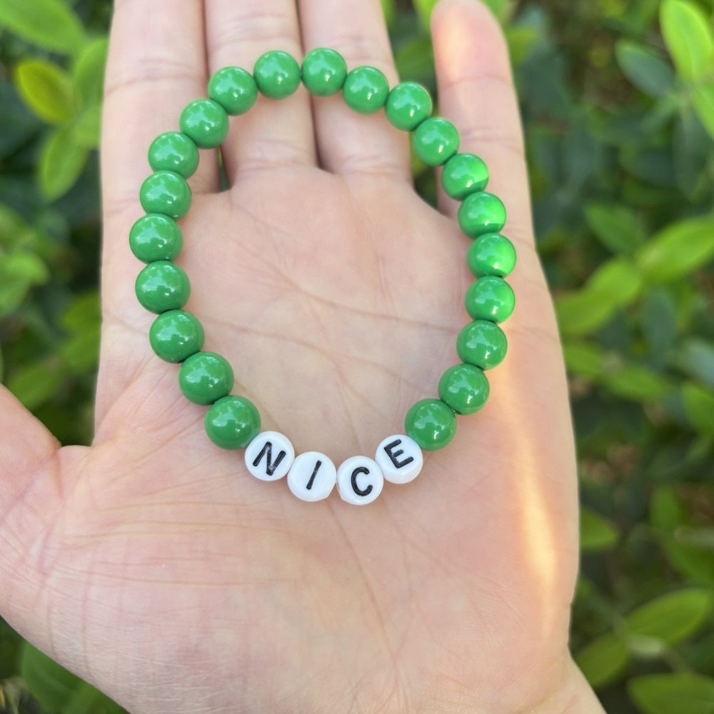 Stackable unisex pastel bead bracelet with 'LOVE' letters. Great for layering beaded friendship jewelry.