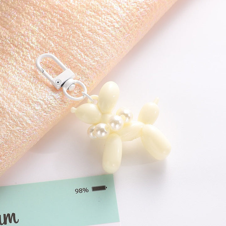 Fashionable balloon dog keychain with an elegant bead charm, a great gift idea.