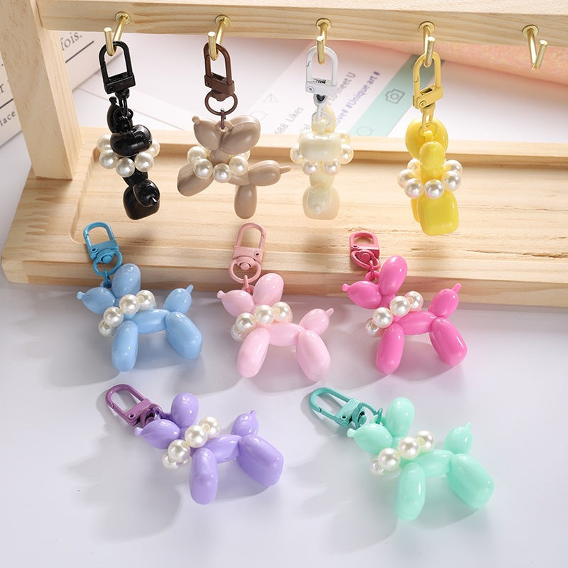 Elegant bead charm on a playful balloon dog keychain, a chic fashion accessory.