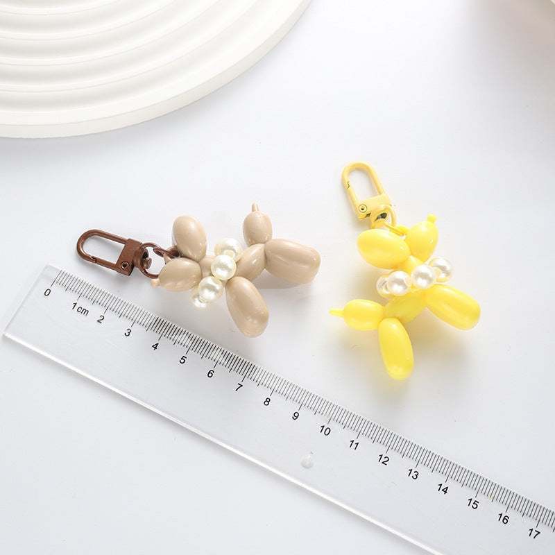 Shiny balloon dog keychain, a playful yet elegant key holder and bag accessory.