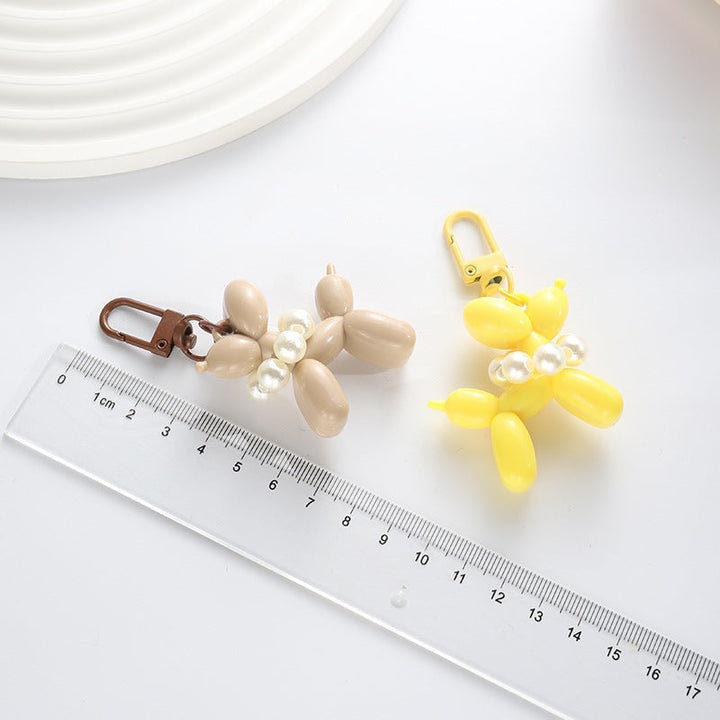 Shiny balloon dog keychain, a playful yet elegant key holder and bag accessory.