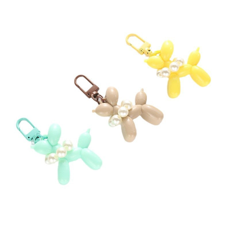 Unisex balloon dog keychain with elegant bead, a delightful and stylish gift idea.