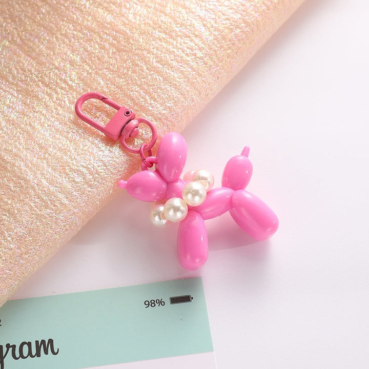 Vibrant balloon dog keychain, a unique key holder and bag accessory with elegant charm.