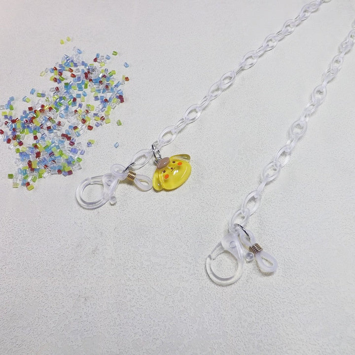 Playful dog charm eyeglass chain, a transparent and stylish holder for all your eyewear needs.