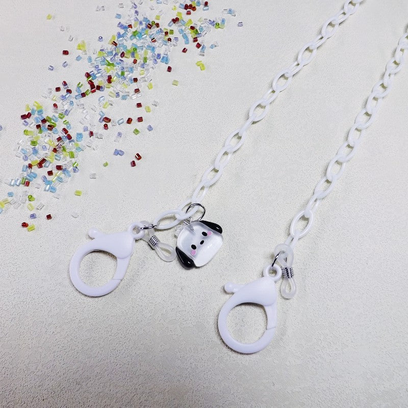 Playful fashion glasses chain featuring a charming dog pendant and clear, durable material.