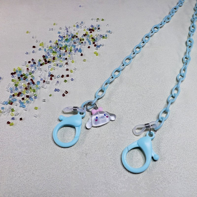 Stylish eyeglass retainer with a playful dog design, made from transparent, lightweight material.