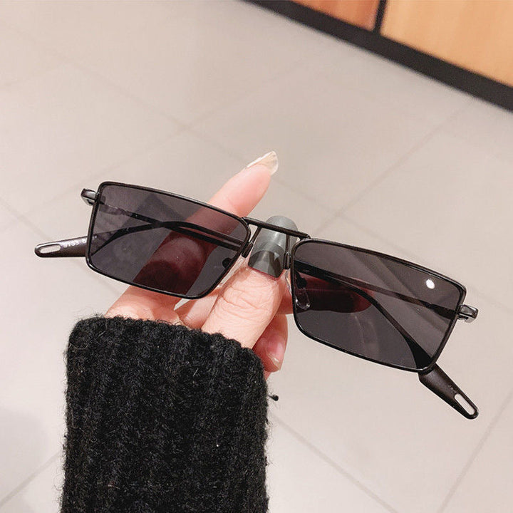 Sleek black unisex rectangular fashion sunglasses, ensuring ultimate UV protection & comfort.