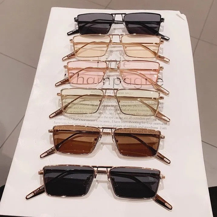 Fashionable rectangular sunglasses, a stylish accessory for men & women, offering elegant design.