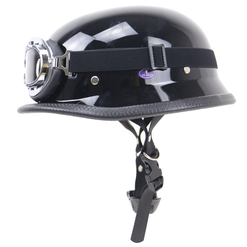 Side view of matte black retro half-helmet motorcycle, showcasing its vintage design & classic goggles.