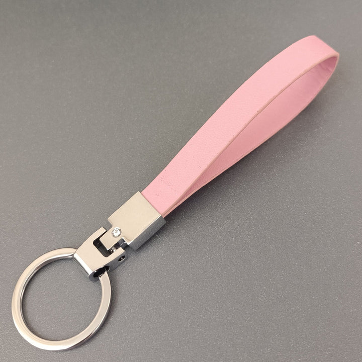 Stylish and durable slim leather key holder, an essential unisex accessory for daily organization.