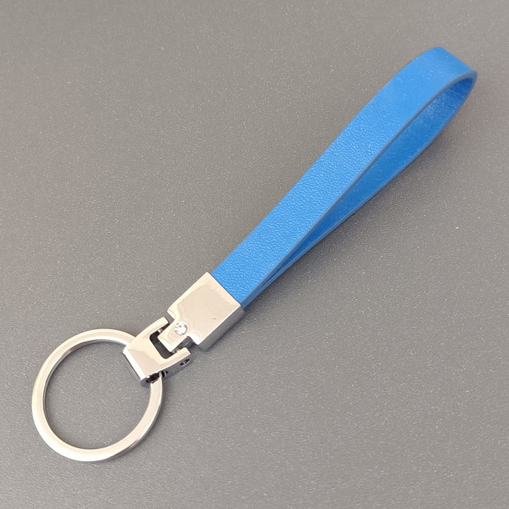 Unisex slim leather keyring shown in hand, demonstrating its comfortable, elegant feel and design.