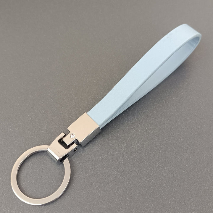 Front view of an elegant slim leather key holder, a minimalist unisex accessory with a secure clasp.