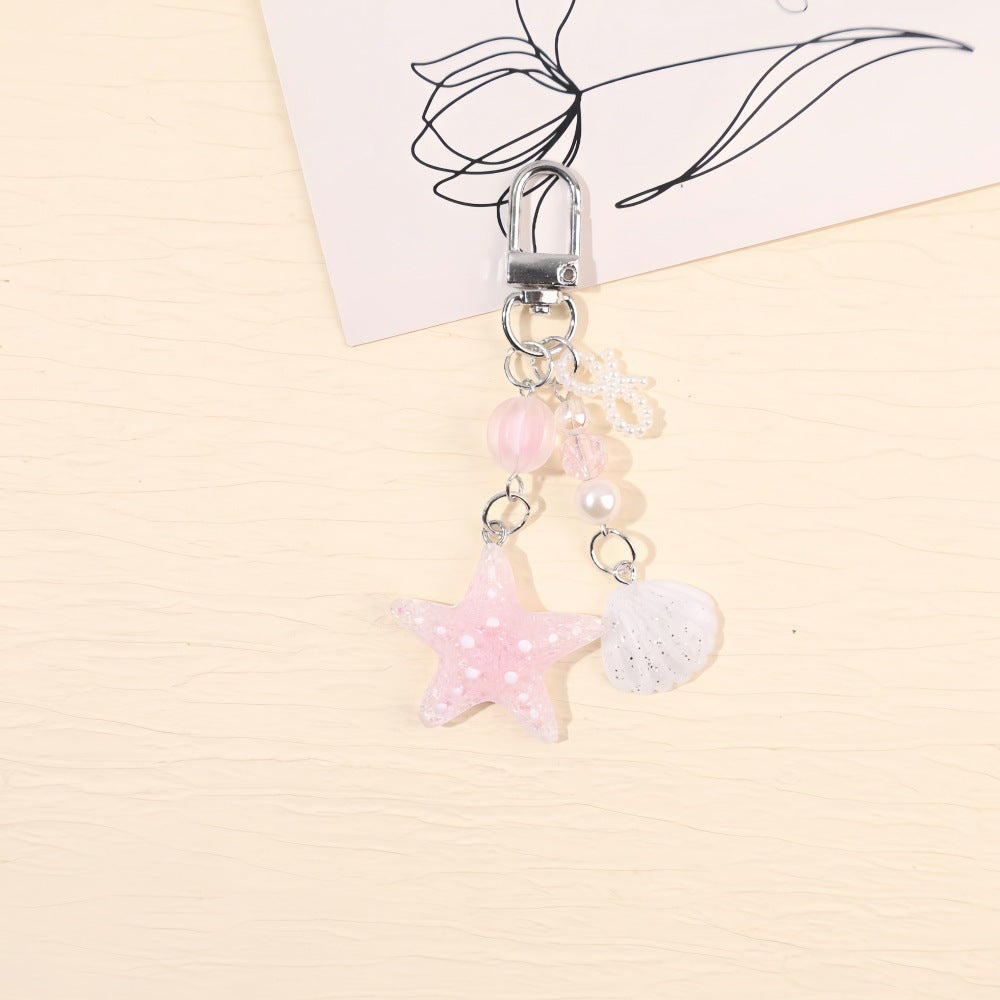 Sparkling maritime star keychain, ideal unisex gift or bag charm, featuring glitter resin accents.