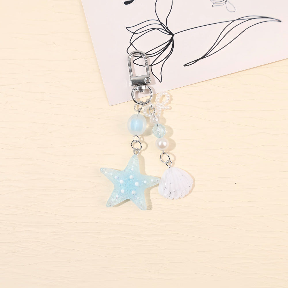 Stylish unisex star bag charm, a sparkling maritime keychain with glitter resin accents.