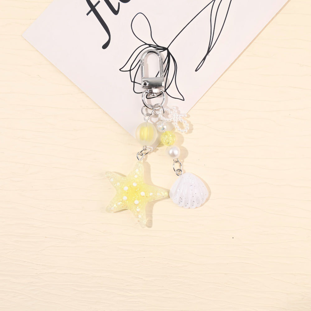Sparkling resin star keychain, unisex maritime accessory with glitter, great for gifts.