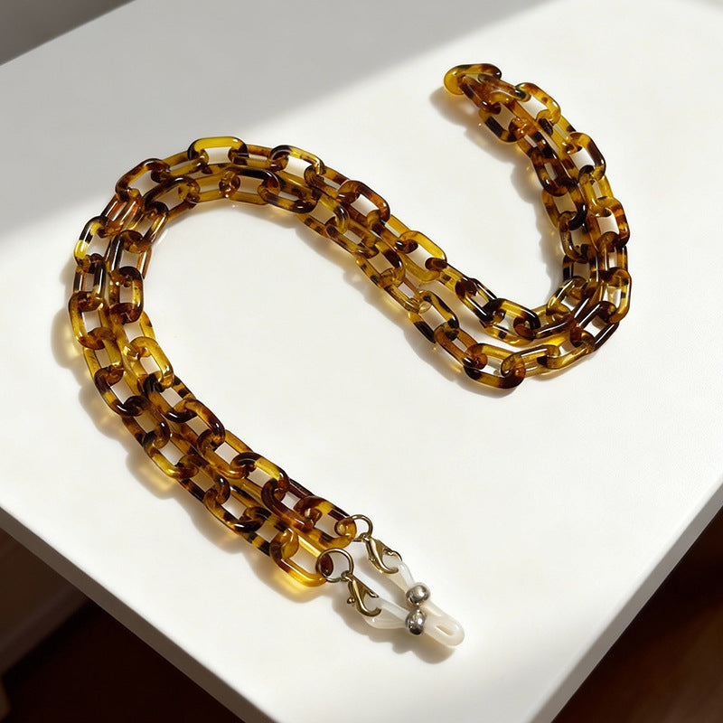 Secure eyewear retainer chain, stylish & lightweight plastic glasses holder, anti-slip feature.
