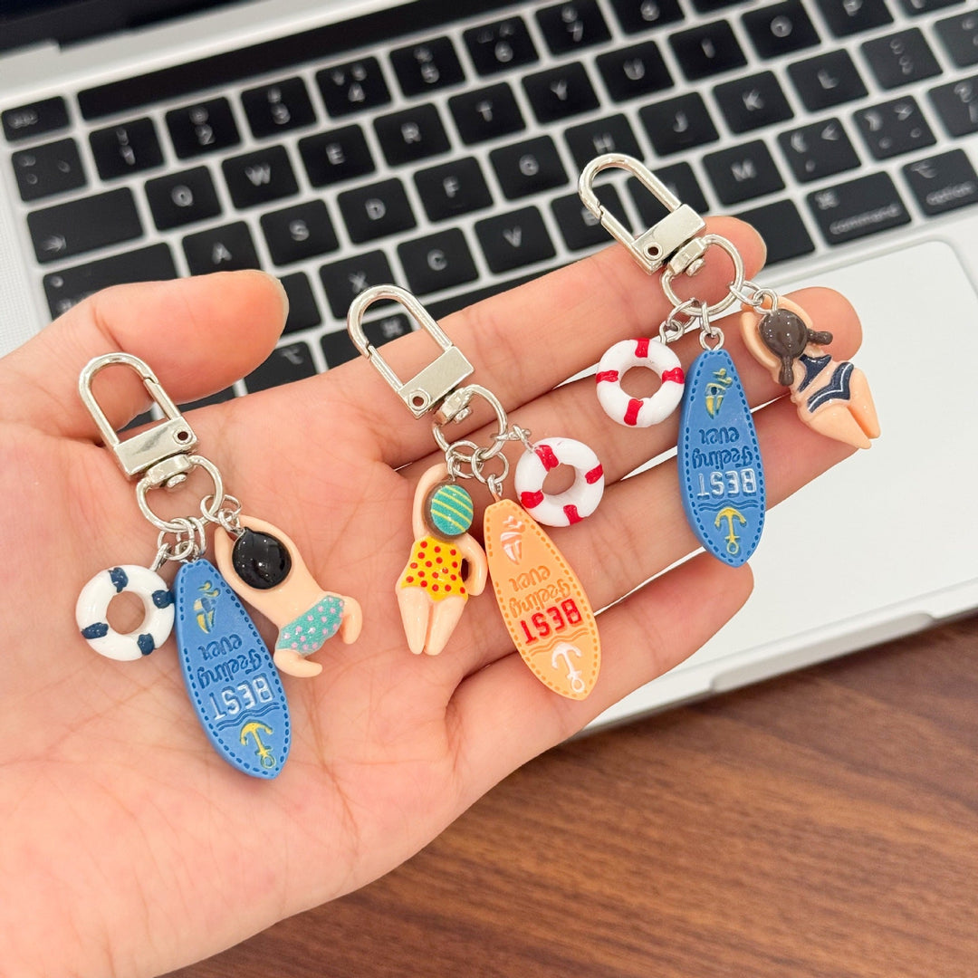Unisex swimming keychain with multiple water-themed charms, perfect for water lovers and beach accessories.
