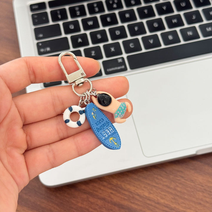 Unique swimming keychain with a cute lifebuoy charm, great as a bag charm for water enthusiasts.