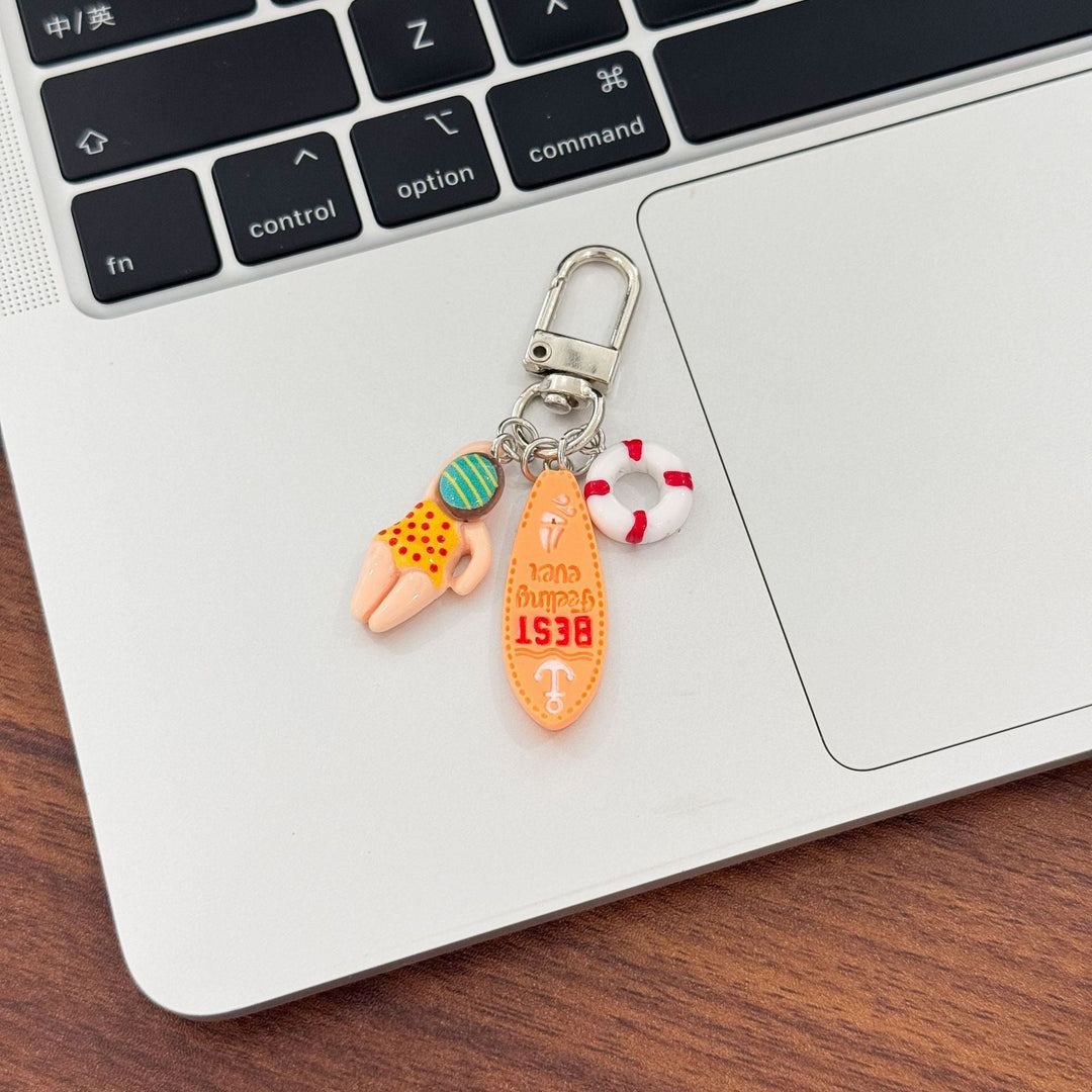 Fun swimming keychain for water lovers, featuring beach-themed charms like a surfboard.