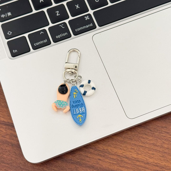 Vibrant swimming keychain, a durable plastic beach accessory and unique bag charm for water lovers.