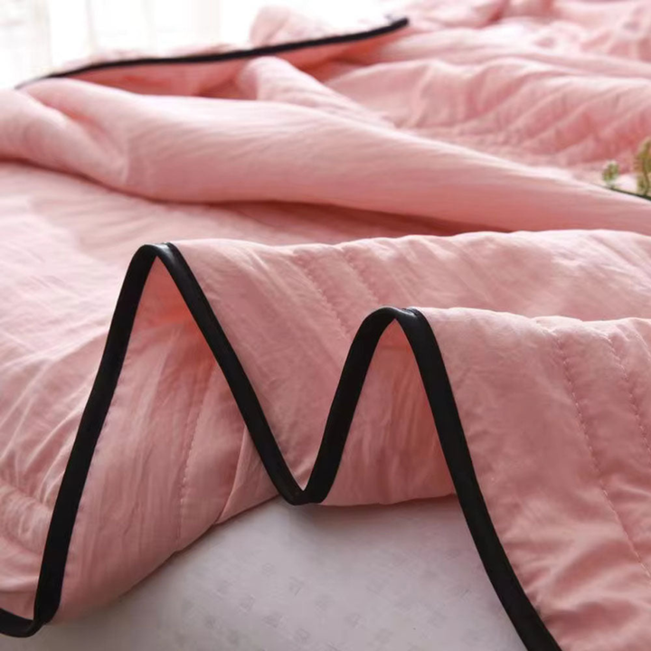 Soft, hypoallergenic cooling blanket in a neutral shade, perfect for comfortable temperature control for hot sleepers.