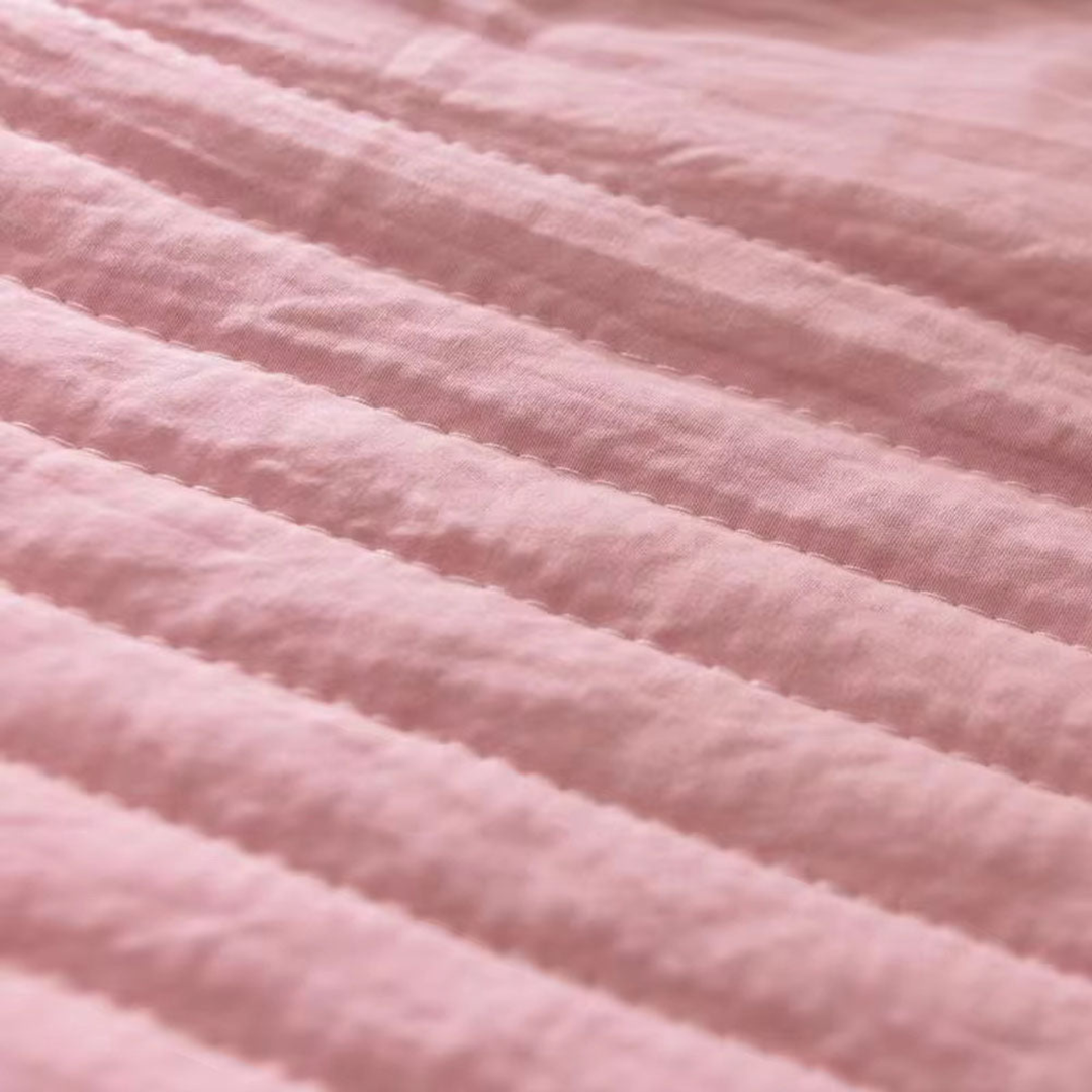 Breathable cooling blanket on a bed, providing ultimate comfort & night sweat relief for hot sleepers of any gender.