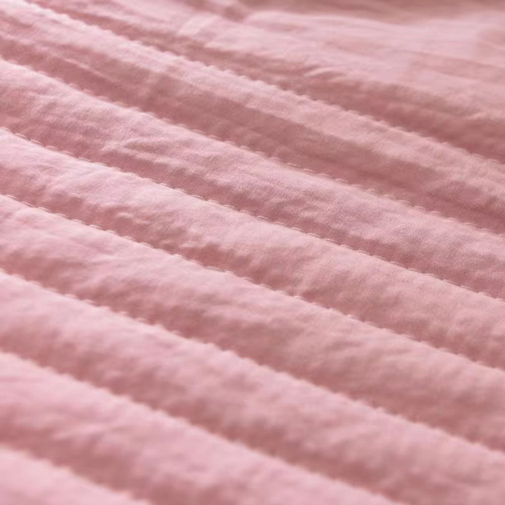 Breathable cooling blanket on a bed, providing ultimate comfort & night sweat relief for hot sleepers of any gender.