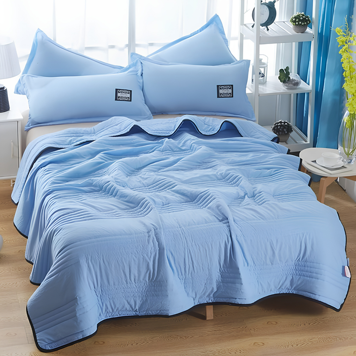 Folded ultimate cooling blanket, a soft and lightweight summer bedding solution for night sweats and hot sleepers.