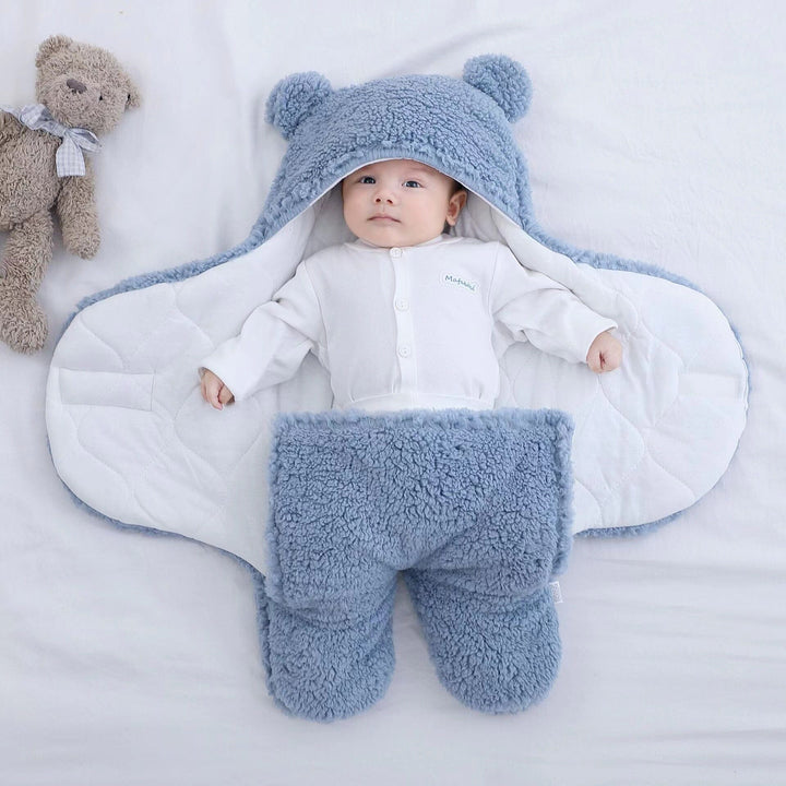 Cozy winter baby sleepsack: quilted plush swaddle with adorable bear ears, ideal for newborn comfort & warmth.