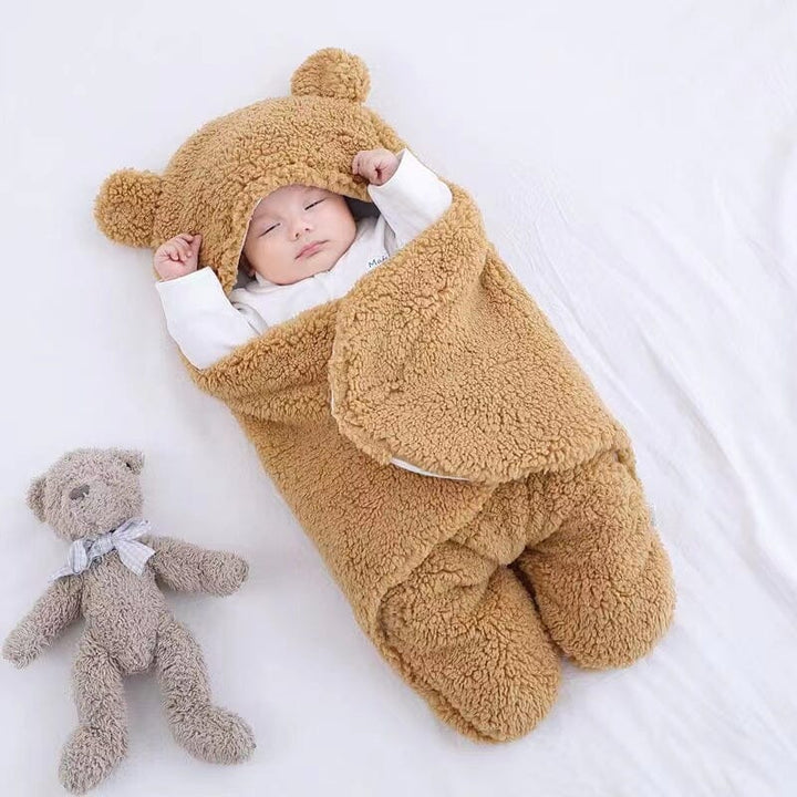 Quilted plush baby swaddle with adorable bear ears, a unisex cozy wrap for newborn and infant winter sleep.