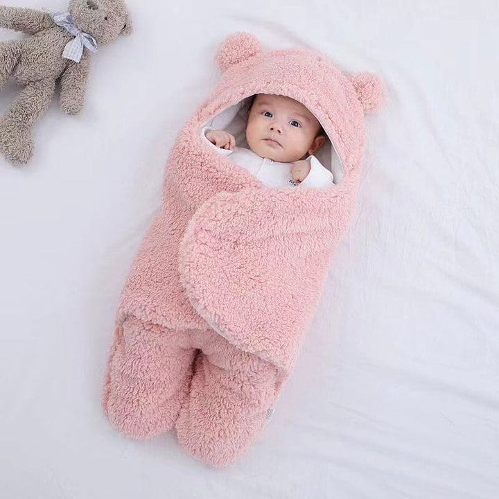 Unisex ultra-soft quilted baby swaddle with bear ears. A warm, cozy wrap for peaceful newborn infant sleep.