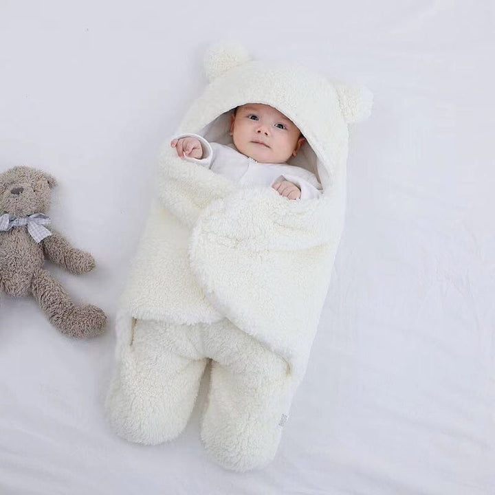 Warm winter baby swaddle: ultra-soft quilted plush with cute bear ears, perfect sleepsack for newborns.