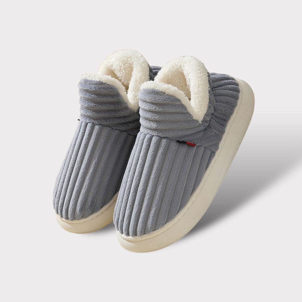 Warm and cozy plush slippers with ergonomic support, perfect indoor footwear for unisex comfort during winter.