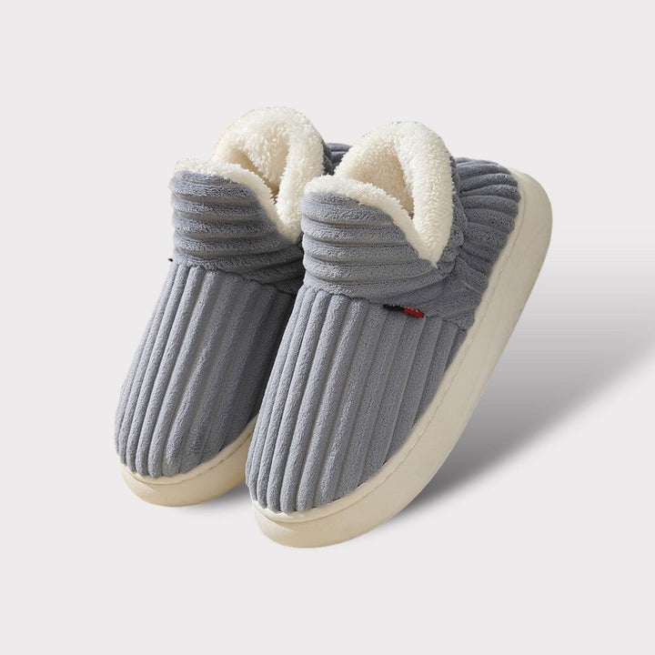 Warm and cozy plush slippers with ergonomic support, perfect indoor footwear for unisex comfort during winter.