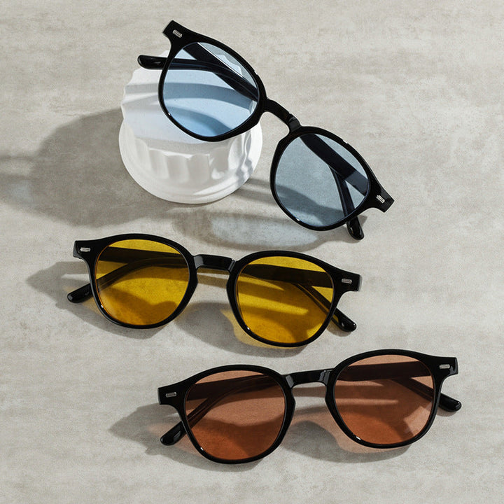 Stylish black frame vintage round sunglasses with yellow lenses & UV protection for men & women.