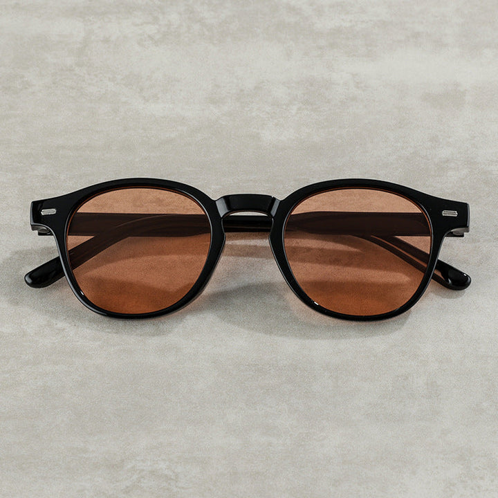 Chic vintage round sunglasses with sleek black frames & UV protective lenses for a stylish look.