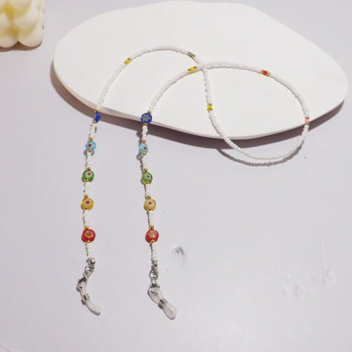 Unisex white beaded glasses chain holder, an elegant eyewear accessory and secure neck strap.