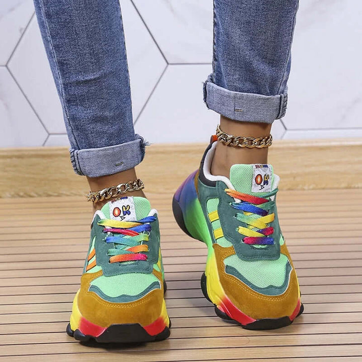 Woman wearing vibrant chunky platform trainers, showcasing trendy casual footwear.