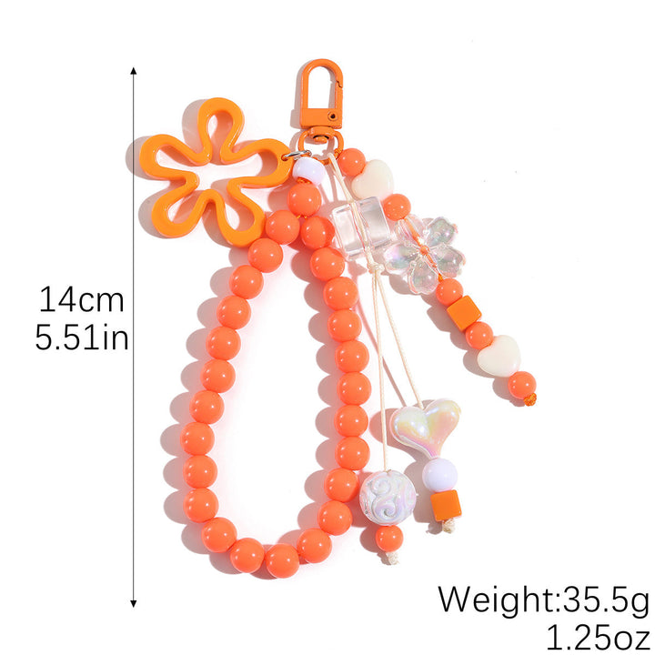 Vibrant plastic butterfly keychain with intricate floral design, a perfect bag accessory.
