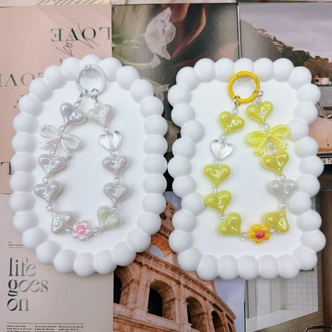 Vibrant heart charm keychain for women, featuring a colorful iridescent finish. Perfect bag accessory & gift.