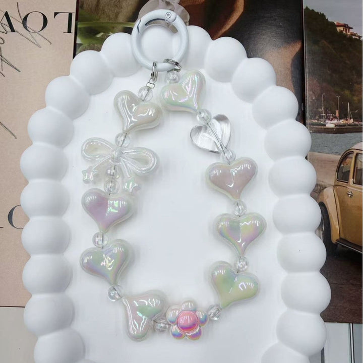 Stylish women's heart charm keychain with a vibrant, colorful iridescent finish. Perfect bag or key accessory.