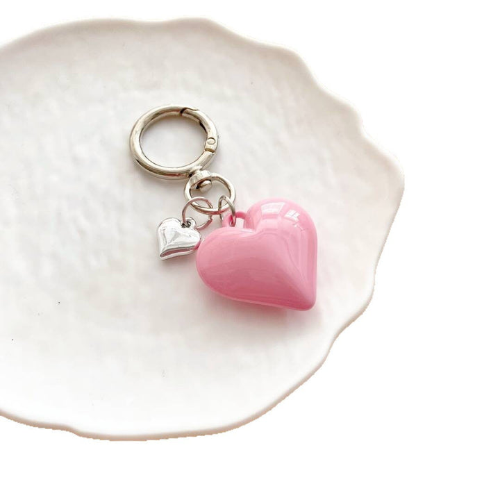 Fashionable women's heart charm, vibrant key holder and purse accessory.