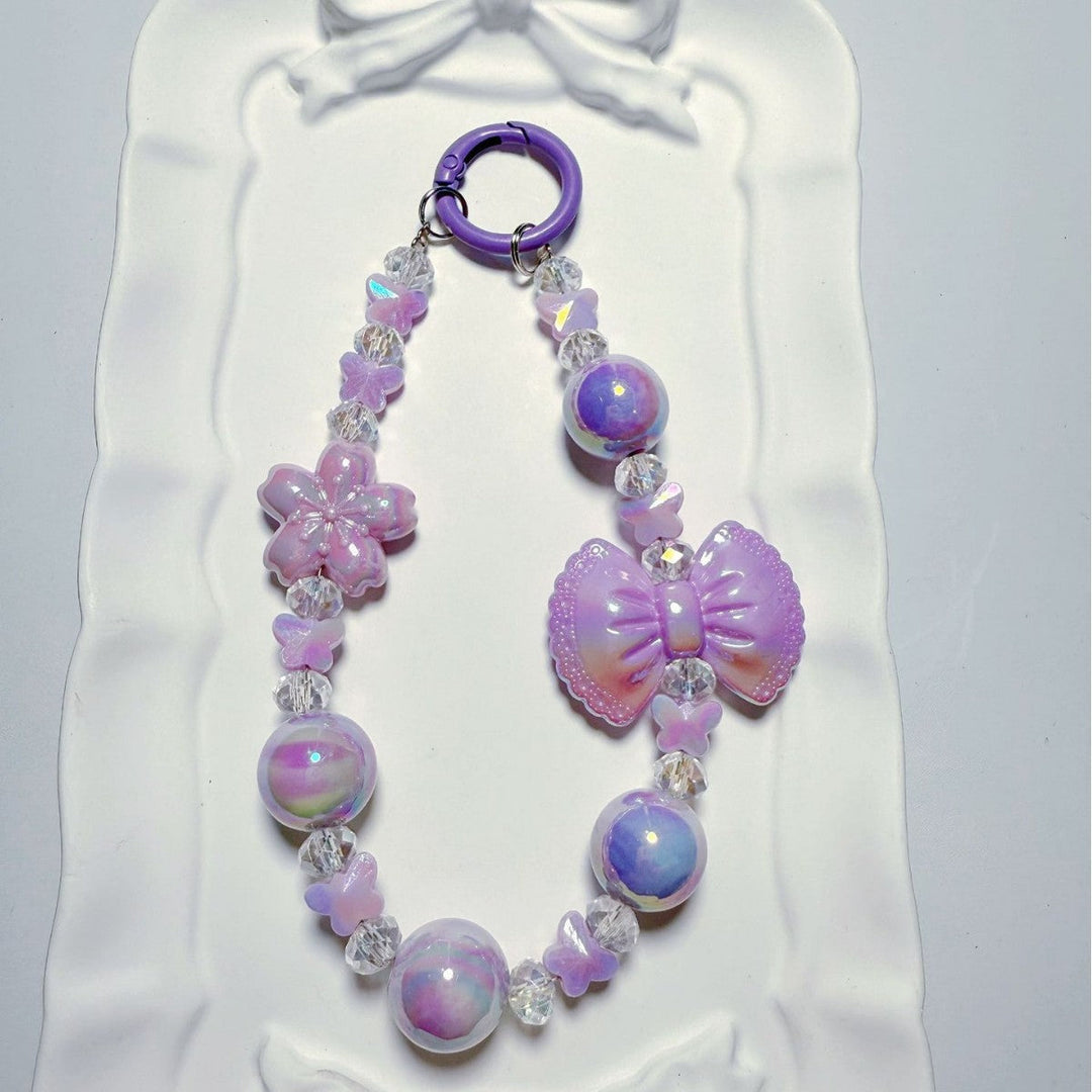 Vibrant iridescent butterfly bag charm & key ring with a stylish bow, a unique women's accessory.