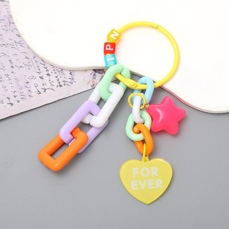 Modern, stylish keychain featuring vibrant plastic chains and playful charms. A unique bag accessory.