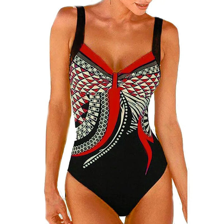 Vibrant printed women's tummy control swimsuit, offering a flattering fit for confident beachwear & poolside style.