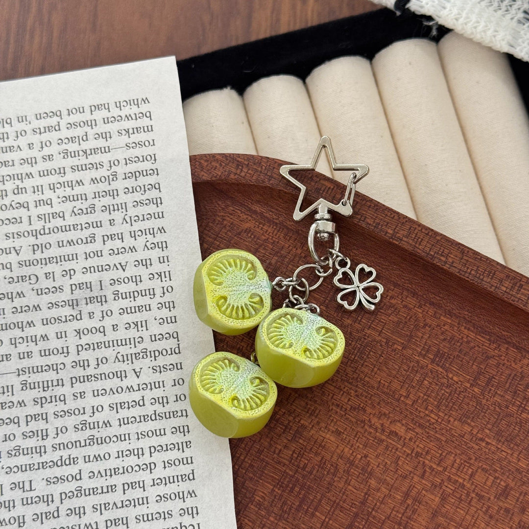 Vibrant red tomato charm keychain with green leaves for bags & keys. Cute novelty accessory gift.